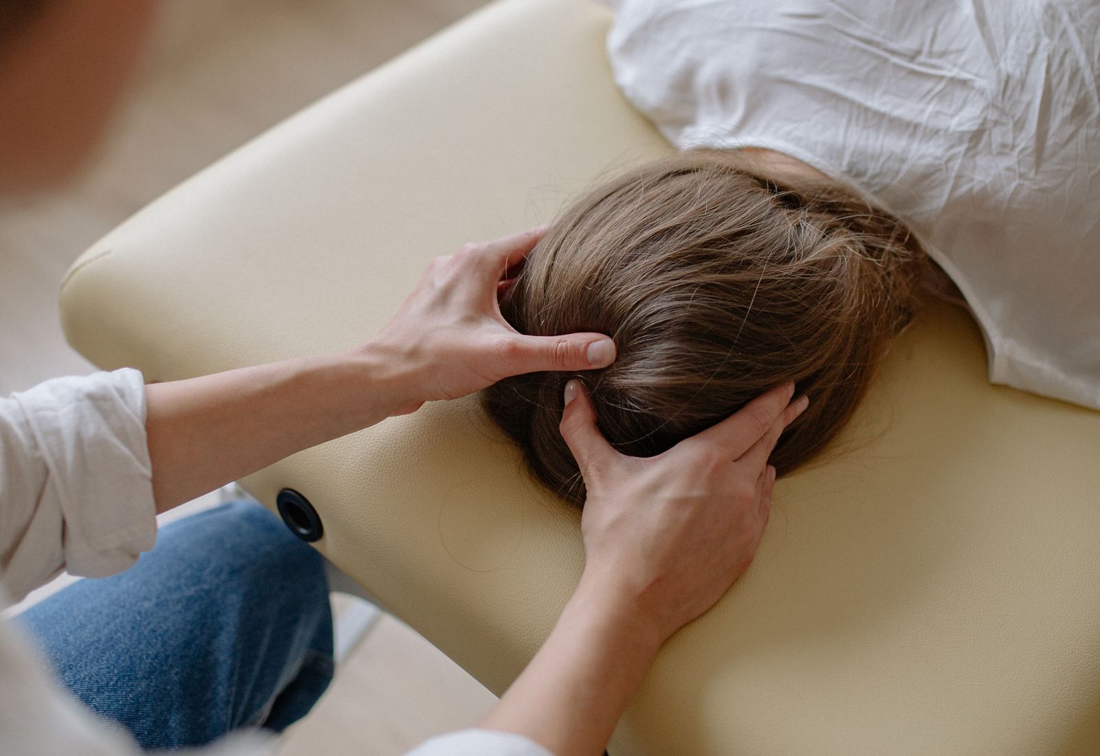 Massage therapist working on a client's neck and shoulders